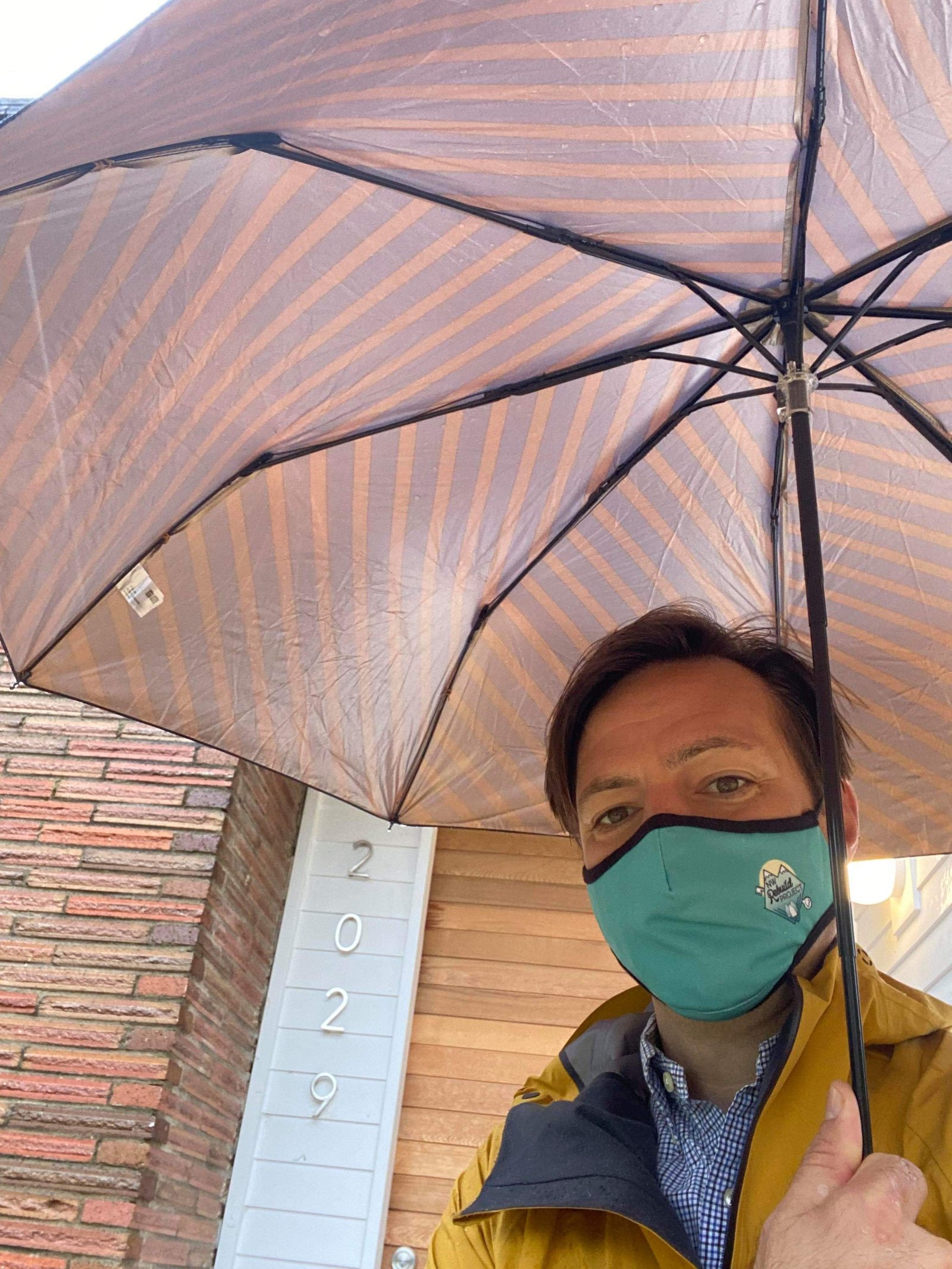 An NW Rebuild Project volunteer on site in the rain